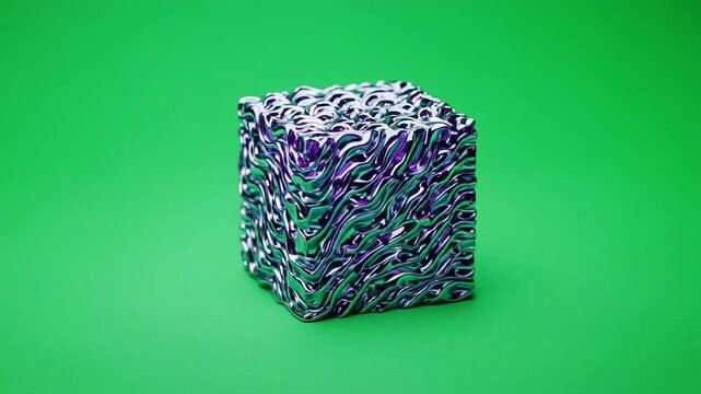 Glitter cube rotating in studio lighting against a vibrant green backdrop