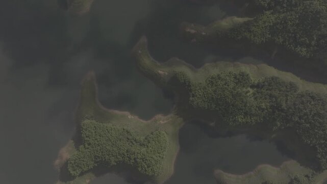 Cinematic aerial shot of scenic island landscape over Ta Dung Lake in Ta Dung Commune, Dak Glong, Dak Nong, Lam Dong Province, Vietnam. D log mode