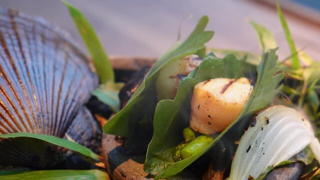 Close-up of grilled scallop dish with smoke rising