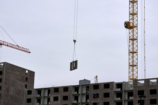 Yellow tower cranes at a construction site of a modern building