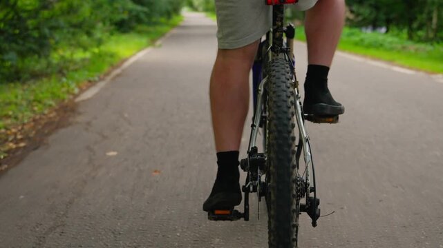 A young man is riding a bicycle