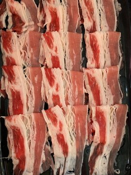 Thinly Sliced Meat for Hot Pot: Perfectly portioned thin slices of marbled meat, ready for a delicious hot pot or barbecue experience, showcasing rich texture and vibrant color.