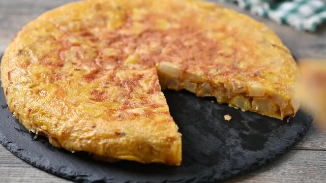 Taking a slice of Spanish potato omelette
