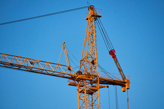 Industrial crane in action at a skyscraper construction site