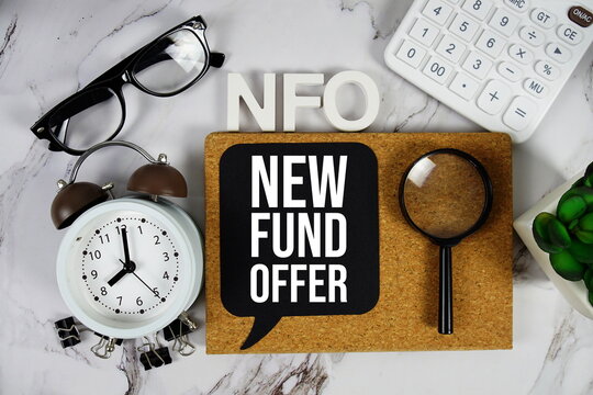 NFO - New Fund Offer acronym with calculator, alarm clock and magnifying glass, Business concept background