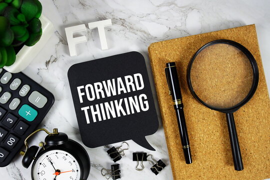 FT - Forward Thinking acronym with calculator, alarm clock and magnifying glass, business concept background