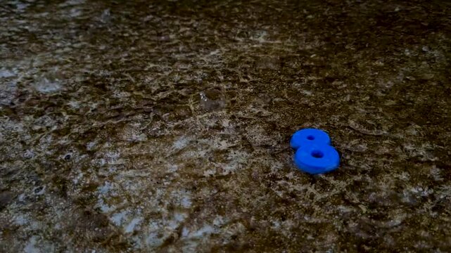 Single blue number eight isolated on dark textured background digit plastic toy math mathematics