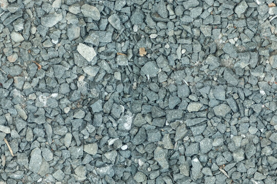 Natural gray crushed stone gravel pile with sharp rocky edges and seamless loop texture for landscaping design.