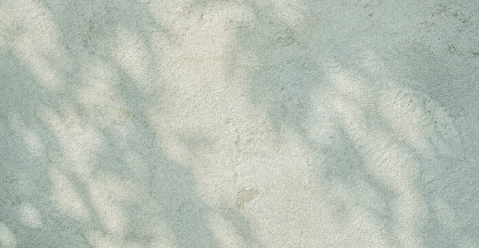 A smooth and textured surface with soft shadows creating a calming pattern. The subtle color and light play provide a serene backdrop for various designs.