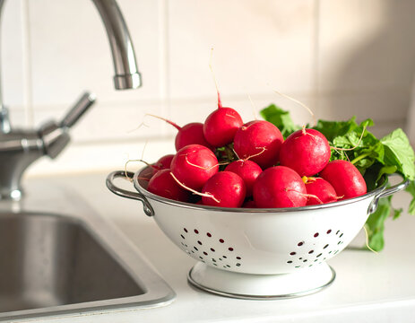 Fresh Radishes in a Colander by the Kitchen Sink.