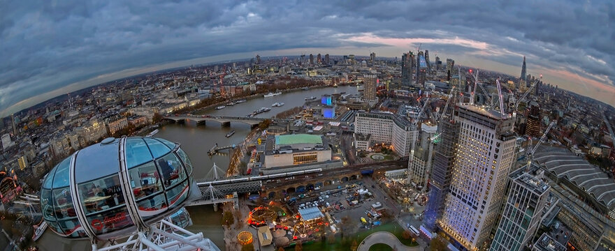LONDON, ENGLAND - NOVEMBER 28, 2017: Panoramic view at oane part of city, at dusk time, from London Eye capsule. Giant Ferris wheel on the Bank of the River Thames has 135m tall and 120m in diameter.