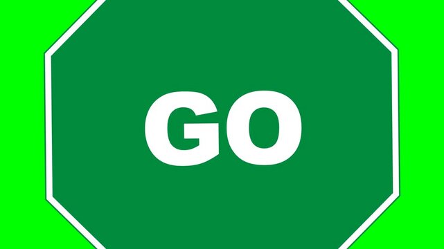 Stop sign in a modified octagonal shape features bright white text on a rich green background to signal proceed.