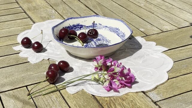 Fresh Cherries Falling into a Vintage Bowl in Slow Motion