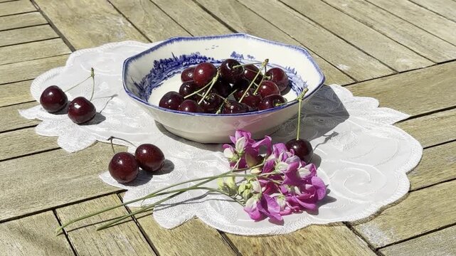 Fresh Cherries Falling into a Vintage Bowl in Slow Motion