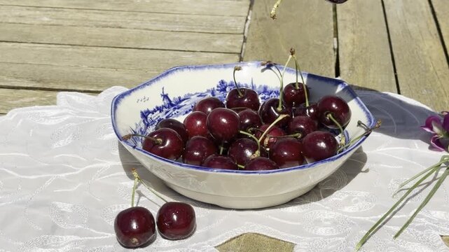 Fresh Cherries Falling into a Vintage Bowl in Slow Motion