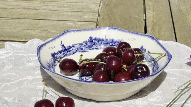 Fresh Cherries Falling into a Vintage Bowl in Slow Motion