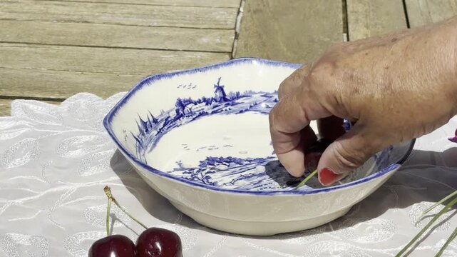 Fresh Cherries Falling into a Vintage Bowl in Slow Motion