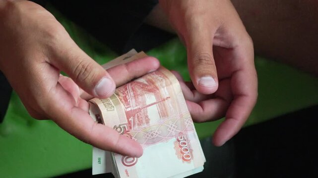 Money counting rubles, close-up hands counting Russian 5000 ruble banknotes