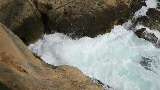 white foam surges across rock ledge cliff top view rugged malta coast wave splash texture close malta coastline mediterranean sea sea spray foaming surf tidal surge wave action coastal erosion