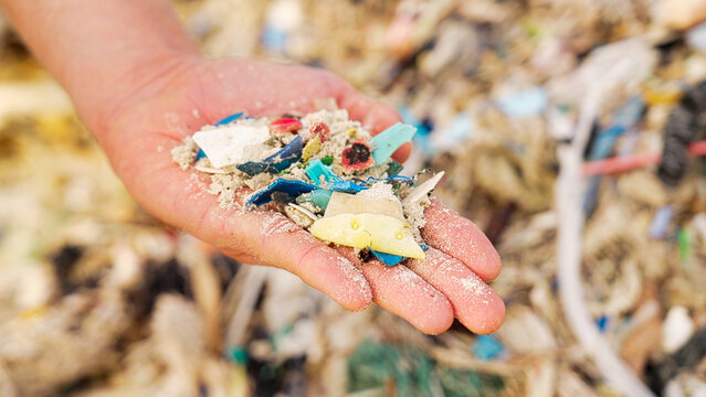 microplastics pollution in sand on beach, plastic waste in ocean