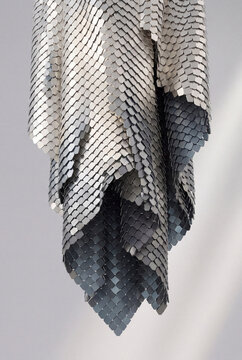 Draped 3D metal scale fabric hanging in folds