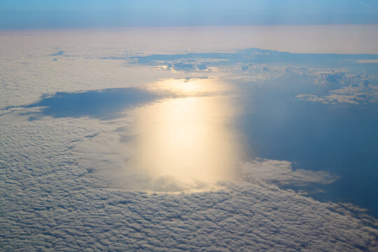 Aerial Sun Reflection On Ocean Through Clouds