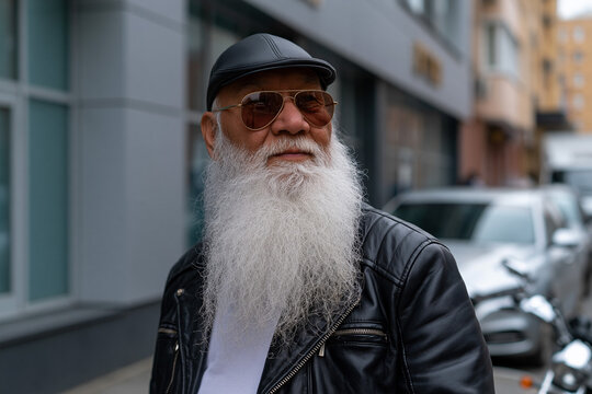 Man with long beard on city street with cars