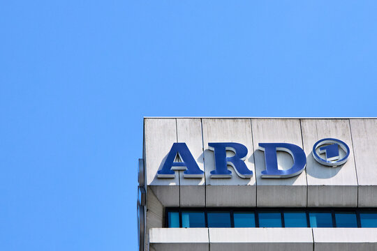 The ARD television network logo on top of the concrete building facade against a clear blue sky in Munich, Germany, representing German public broadcasting media.