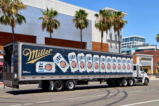 Commercial delivery semi truck with Miller Lite beer advertising driving on a city street in Long Beach, California.