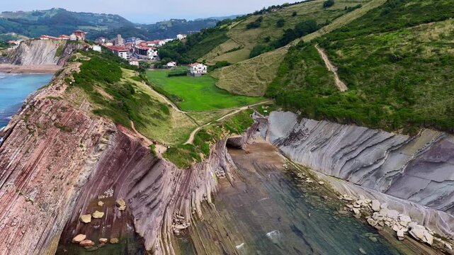 Dramatic aerial landscape on Basque Country coast in Spain, coastal town of Zumaya and flysch Itzurun beach drone view, Atlantic shore line in northern Spain, travel in Basque Country