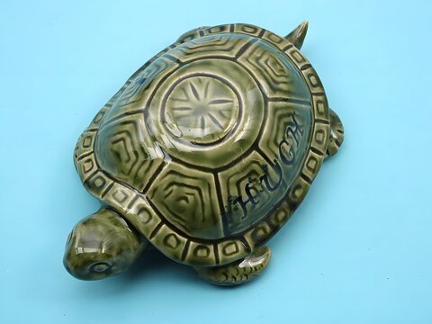 Handcrafted green stone turtle sculpture with intricate Aztec pattern carving on shell