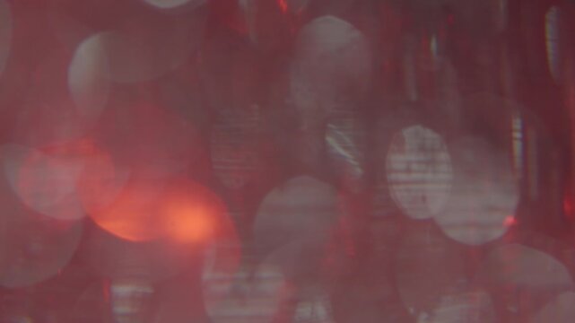 A background video featuring shimmering red and white sparkles, conveying a sense of mystery, luxury, and sophistication.