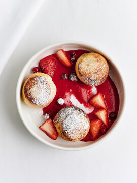 Cottage cheese pancakes with berry sauce and fresh fruit, dessert menu, cafe offering