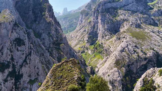 aerial landscape in the Picos de Europa mountains, Spain, hiking in Picos de Europa, deep canyon with dramatic mountain peaks, rugged rocky ridges, trekking in Spain