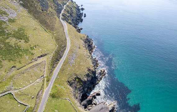 Drone aerial scenery Dingle peninsula coastal road winding along the rocky atlantic ocean coastline. Ireland, Irish landscape. Scenic route road trip