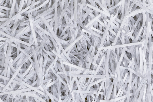 Background texture of white shredded paper strips top view close up