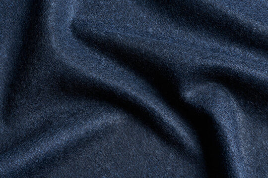 Dark blue soft cashmerelike wool fabric with folds texture