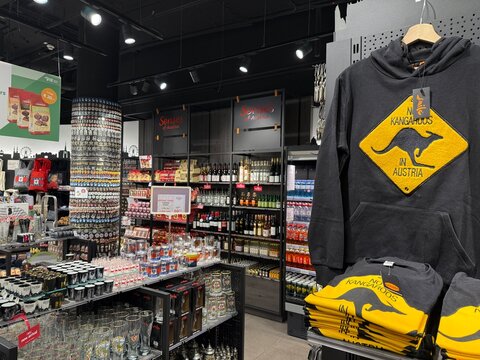 Schwechat, Lower Austria - June 22, 2026: Airport souvenir shop selling souvenirs, as prominent hoodie with yellow warning sign with text 'No Kangaroos in Austria' and regional gifts and memorabilia.