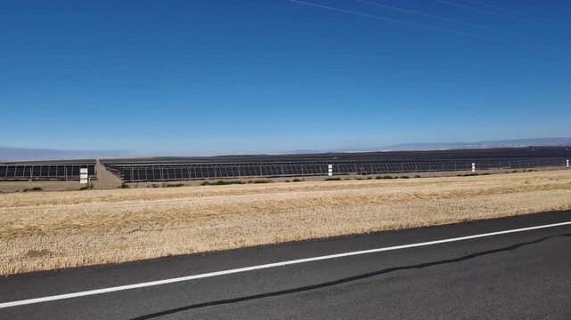 4K smooth stabilized footage of a large solar panel farm in north eastern Oregon, USA. Ground level view of renewable energy infrastructure generating clean electricity across the Pacific Northwest