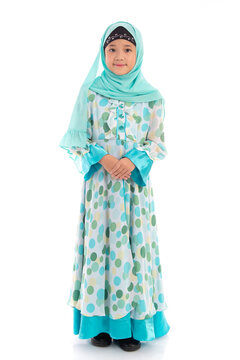 Charming young Muslim girl with hijab posing politely with hands clasped isolated on white background.