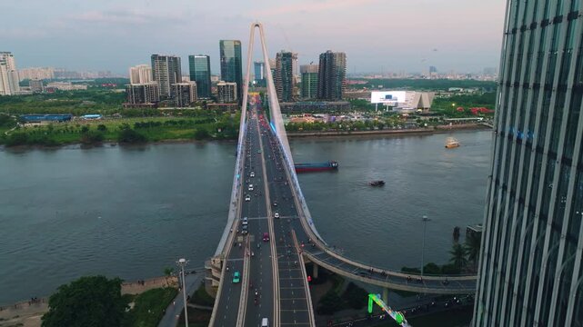 Aerial Shot of Ba Son Bridge Crossing Saigon River in Ho Chi Minh City
Shows evening road traffic commuting across the bridge connecting District 1 with the Thu Thiem urban area against a modern high-