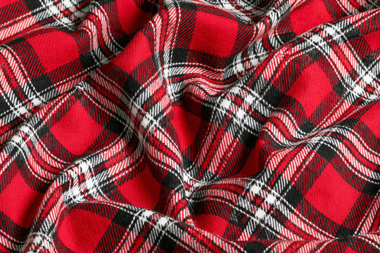 Folded red and black plaid flannel fabric texture background pattern