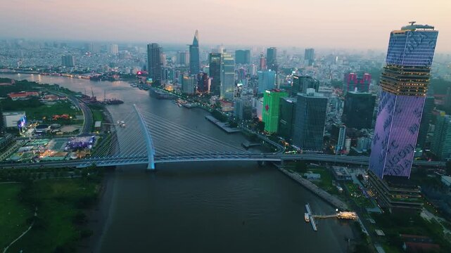 Aerial Shot of Ba Son Bridge Crossing Saigon River in Ho Chi Minh City
Shows evening road traffic commuting across the bridge connecting District 1 with the Thu Thiem urban area against a modern high-
