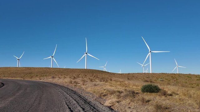 4K pocket action camera footage of a wind farm near Arlington, Columbia River Gorge, Oregon, USA at morning light. Rotating wind turbines producing clean renewable electricity in strong winds