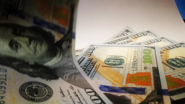 Fast motion shot of 100 US dollar bills flipping and fluttering. Concept of fast cash, high revenue, passive income, rich lifestyle, financial success.
