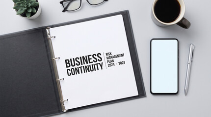 Naklejka premium Business Continuity Plan Concept Flat Lay Binder on Grey Workspace Table
