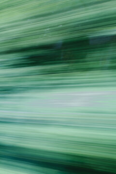 Abstract green motion blur nature background with diagonal light streaks