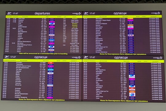 Belgrade, Serbia &ndash; June 25, 2026: Large flight departure information board showing scheduled times, destinations, flight numbers and status remarks in English and Cyrillic at airport terminal.