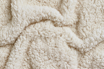 Soft and fluffy white curly wool or faux fur texture © Clint