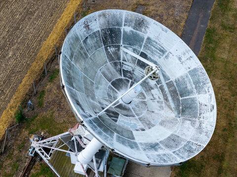 Satellite Dish Antenna Pointed Towards the Sky at a Field During the Daytime